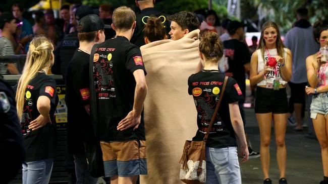 Schoolies festival on the Gold Coast with the Red Frog Crew (in black) — Picture AAP/David Clark