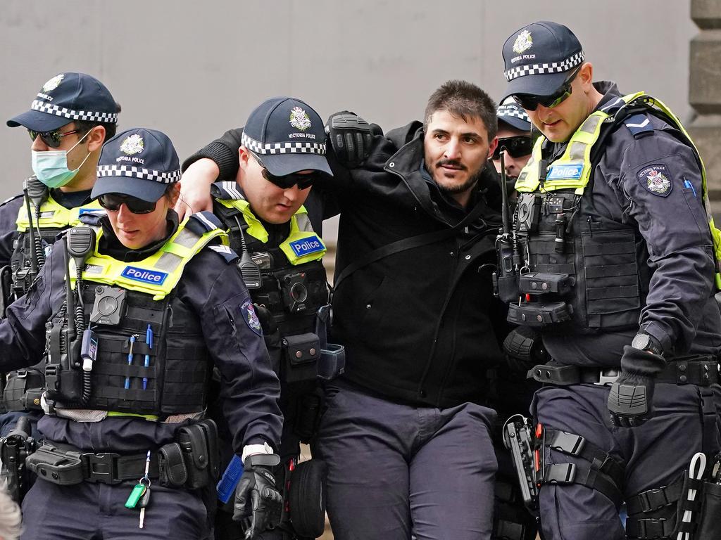 Fanos Panayides is detained by police officers on May 10. Picture: Scott Barbour/AAP