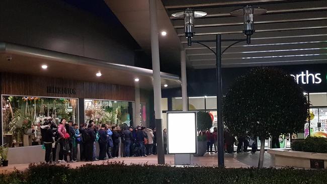 Shoppers, believed to be daigou, queue outside Woolworths at Chadstone. Picture: Reddit