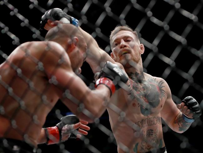 Conor McGregor of Ireland punches Eddie Alvarez in their UFC lightweight championship fight.