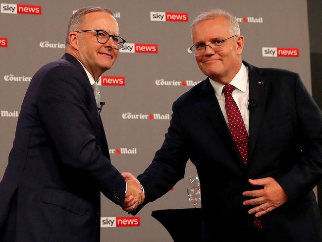 Australian Prime Minister Scott Morrison (R) shakes ahnds with leader of the opposition, Anthony Albanese, during the first leaders' debate of the 2022 federal election campaign at the Gabba in Brisbane on April 20, 2022. (Photo by Toby Zerna / various sources / AFP)