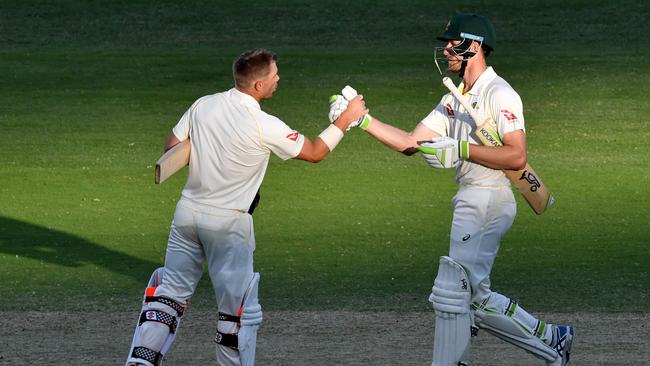 David Warner (left) and Cameron Bancroft (right) of Australia congratulate each other at stumps on Day 4 of the First Ashes Test match between Australia and England at the Gabba in Brisbane, Sunday, November 26, 2017. (AAP Image/Darren England) NO ARCHIVING, EDITORIAL USE ONLY, IMAGES TO BE USED FOR NEWS REPORTING PURPOSES ONLY, NO COMMERCIAL USE WHATSOEVER, NO USE IN BOOKS WITHOUT PRIOR WRITTEN CONSENT FROM AAP