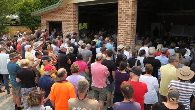 Residents listen to safety advice at a public meeting at Yarramalong RFS station in light of the looming Grospers Mountain fire. Picture: Richard Noone