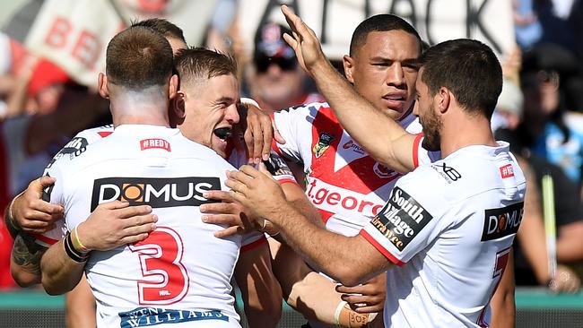 Matthew Dufty is congratulated by Dragons teammates after scoring a try against the Titans at Clive Berghofer Stadium in Toowoomba.