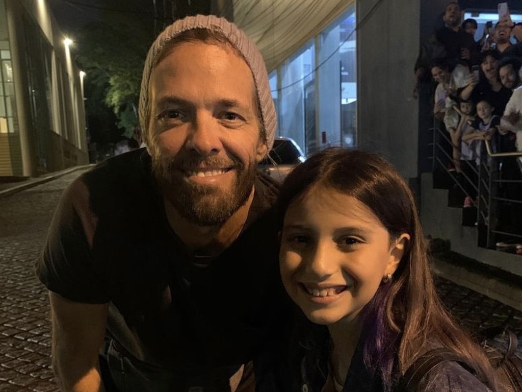 Taylor Hawkins with a young fan in Paraguay. The drummer was found dead in a hotel room in Bogota. Picture: Supplied