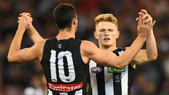 Adam Treloar and Scott Pendlebury.