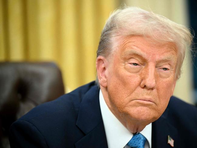 (FILES) US President Donald Trump speaks to the press after signing an executive order in the Oval Office of the White House in Washington, DC on January 31, 2025. Trump is imposing steep tariffs on major US trading partners Canada, Mexico and China, with a lower rate on Canadian energy imports, said the White House on February 1, 2025. Washington will impose a 25 percent levy on imports from Canada and Mexico, with a 10 percent rate on Canadian energy resources, until both work with the United States on drug trafficking and immigration. Goods from China, said the White House, would face 10 percent tariffs. (Photo by Mandel NGAN / AFP)