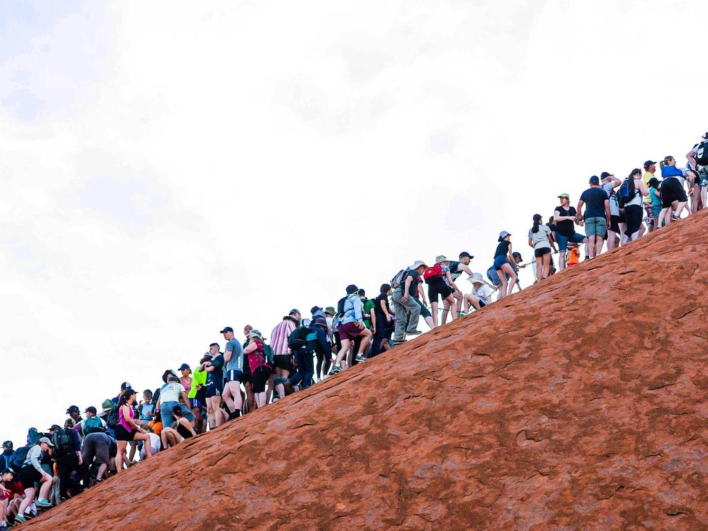 There are crazy scenes on Uluru as tourists rush to make the climb. Picture: Amos Aikman