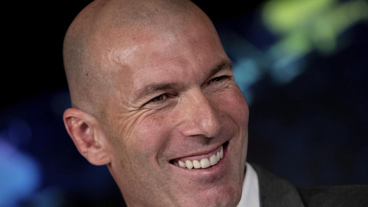 Newly-appointed Real Madrid head coach Zinedine Zidane smiles during a press conference.
