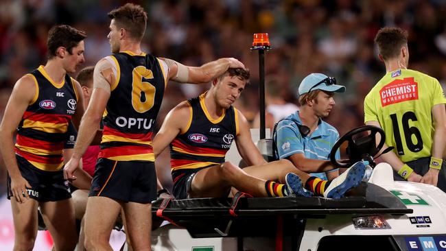 Bryce Gibbs consoles dejected Paul Seedsman as he is taken off Adelaide Oval. Picture: James Elsby/AFL Photos/Getty Images