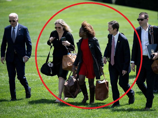 Staff walk alongside US President Joe Biden (L) as they walk from Marine One to the residence of the White House in Washington, DC, on April 26, 2024, after traveling to New York. (Photo by Brendan Smialowski / AFP)