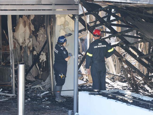 Fire investigators in the ruins. Picture: Peter Wallis