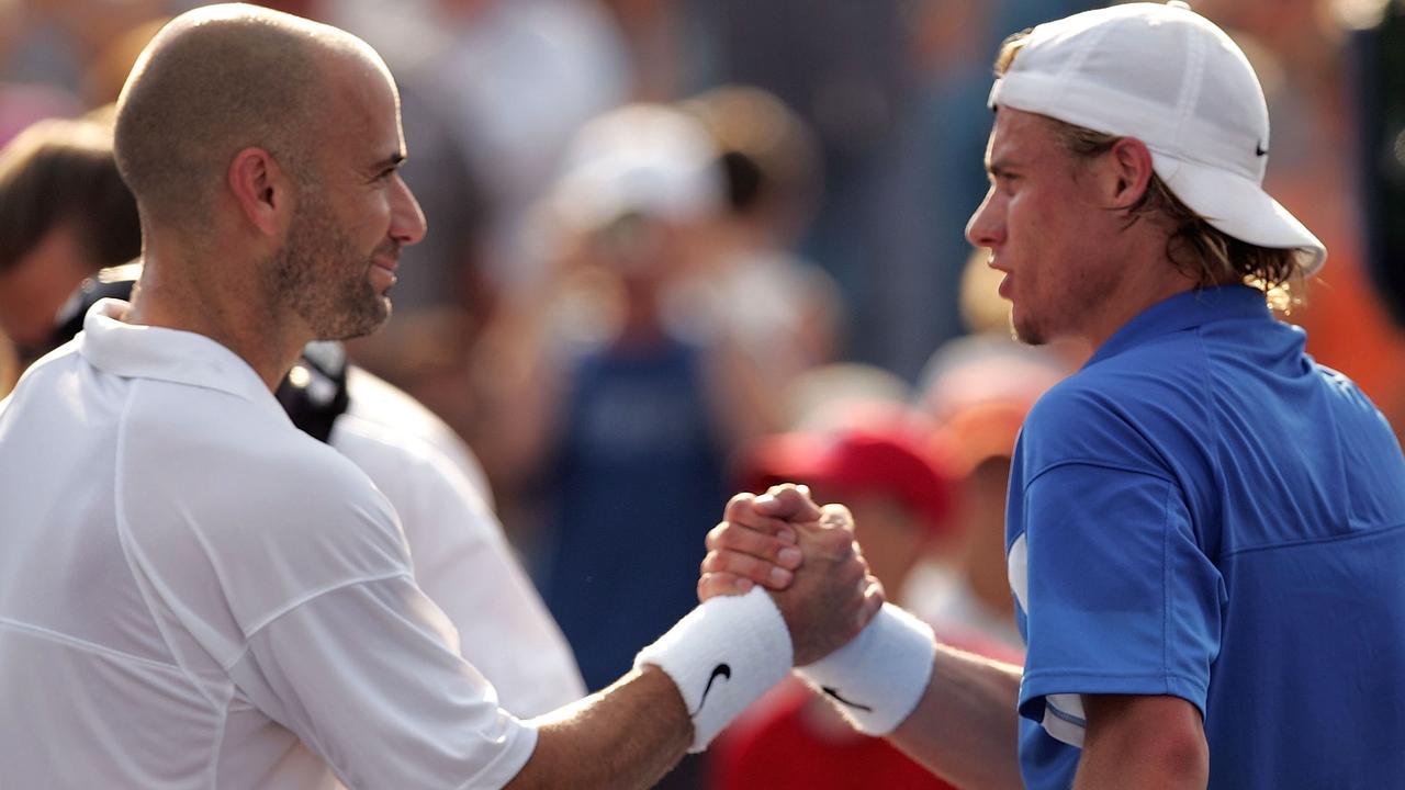 Andre Agassi with Australian tennis champ Lleyton Hewitt of Australia in the championship match during the Western and Southern Financial Group Masters on August 8, 2004.