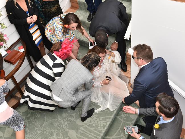 Gina Rinehart falls down the stairs in the Emirates marquee on Melbourne Cup Day at Flemington Racecourse. Picture: Julian Smith