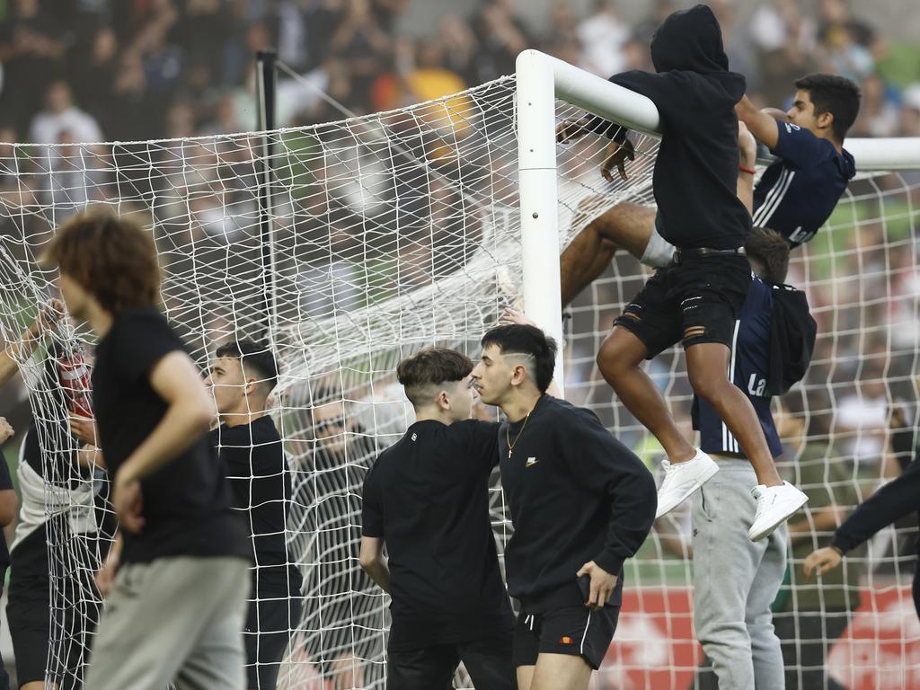 The pitch invaders started climbing the goalposts. Picture: Darrian Traynor/Getty Images