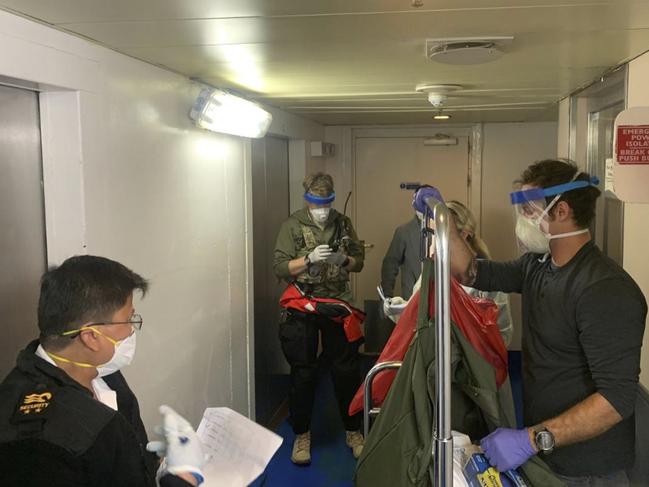 A group of medical personnel with the 129th Rescue Wing, working alongside individuals from the Centers for Disease Control and Prevention, don protective equipment after delivering virus testing kits to the Grand Princess cruise ship. Picture: AP