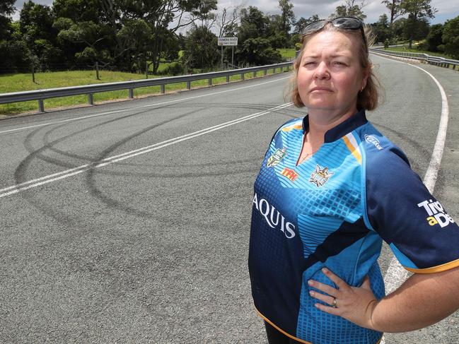 Local resident Lisa Smith beside tyre marks left by hoons next to the bridge over Coomera River at Guanaba Creek Rd. Picture: Glenn Hampson.