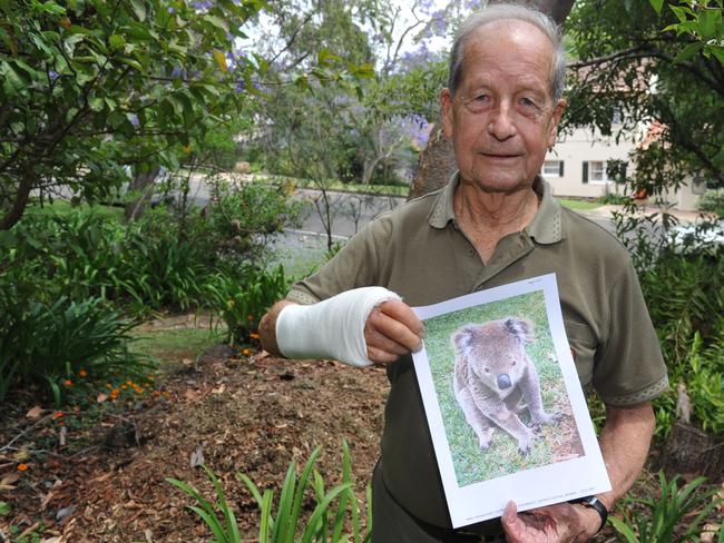 Mr Barnett with a photo of his attacker.