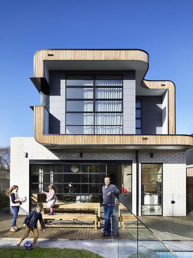 Simone and Garrick Rollason with children, Chloe, 13, Isaac, 10, and Sienna, 7, at their new home by Jost Architects. Photographer: Armelle Habib and Greg Elms