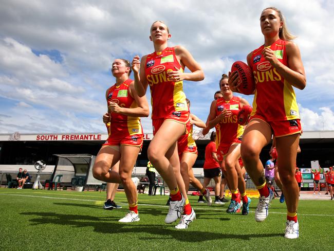 Suns players enter the field before the start of play during the AFLW semi final 4 match between the Fremantle Dockers and Gold Coast Suns at Fremantle Oval in Perth, Saturday, March 21, 2020. (AAP Image/Richard Wainwright).