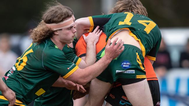 Mittagong’s David Eccleston with an un-orthodox tackle on The Oaks Matthew Richards. News Local, Pictures by Julian Andrews.