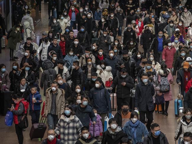 Chinese passengers arriving to board trains before the annual Spring Festival at a Beijing railway station. Picture: Kevin Frayer/Getty