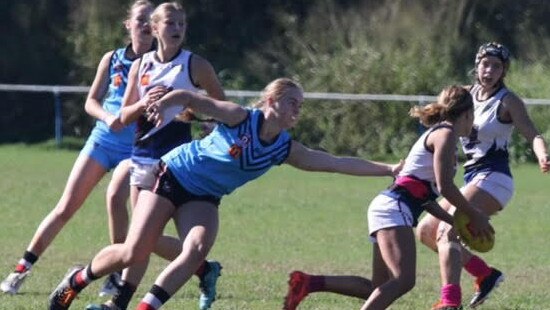 Charlotte Schubert reaching for a tackle in her 50th match for Wynnum.