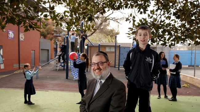 Rabbi Smukler with prep student Eitan and other students from Yeshivah Beth Rivkah college near Melbourne. The school is becoming the first one to cap its fees, and charge differential fees according to parents' income.