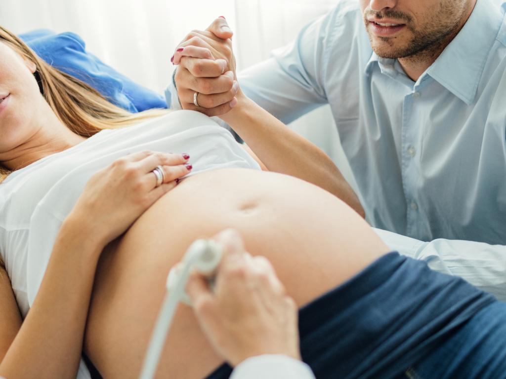 Ultrasound Examination In Doctors Office. Woman and her man in doctors office doing ultrasound examination  Picture: Istock