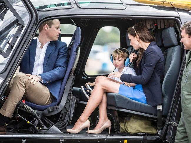 Prince George sits in a helicopter with his mother Catherine, Duchess of Cambridge and father Prince William during a visit to the Royal International Air Tattoo at RAF Fairford in western England. Picture: AFP Photo