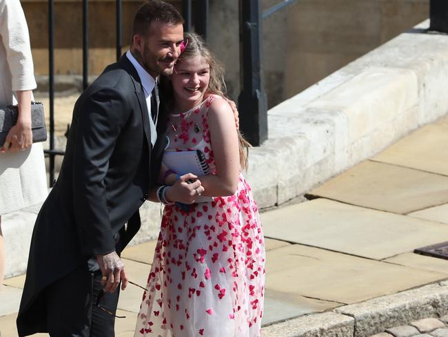 Amelia Thompson gets a hug from David Beckham as he arrives at St George's Chapel for the wedding of Meghan Markle and Prince Harry. Picture: Getty