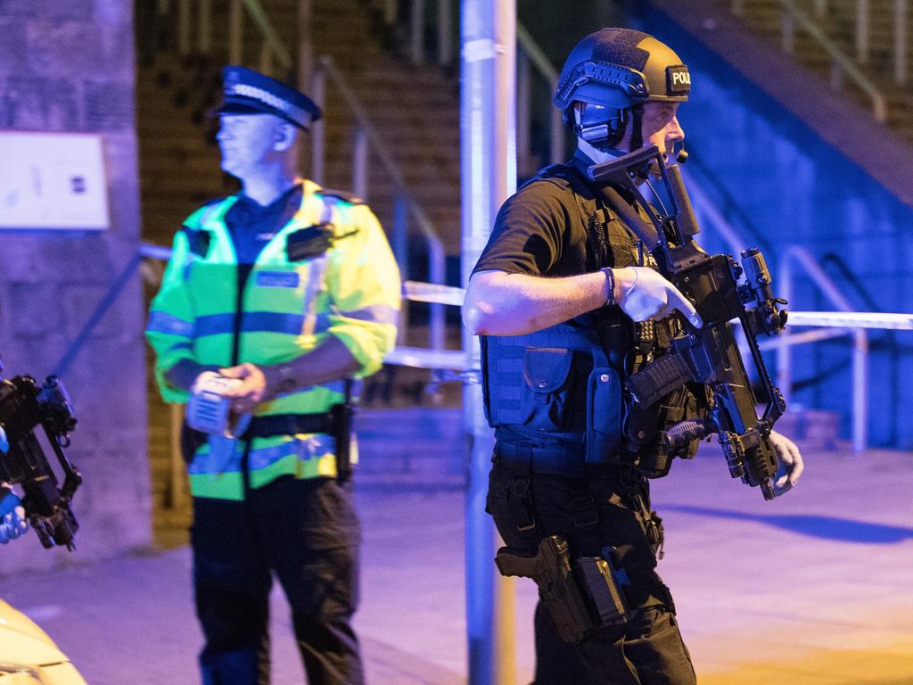 Police and other emergency services are seen near the Manchester Arena after reports of an explosion during an Ariana Grande concert. Picture: Joel Goodman/LNP