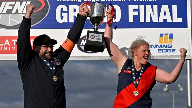 Diamond Creek coach Colin Wallington and captain Stacey Cross lift the cup. Picture: Andy Brownbill