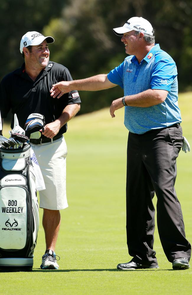 Boo Weekley has a laugh with his caddie.