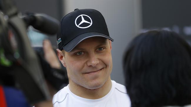 Mercedes driver Valtteri Bottas of Finland talks to journalist at the paddock during a Formula One pre-season testing session at the Catalunya racetrack in Montmelo, outside Barcelona, Spain, Tuesday, March 7, 2017. (AP Photo/Francisco Seco)