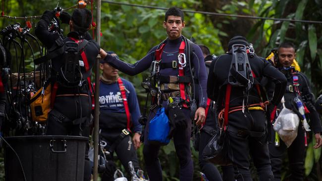 Thai divers carry supplies as rescue operations continue for 12 boys and their coach trapped at Tham Luang cave in Mae Sai. Picture: AFP
