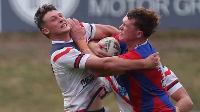 Roosters Tulyson McCulloch fended off by Newcastles Noah McNamara SLE Andrew Johns Cup Newcastle Knights v Central Coast Roosters at Cessnock Sportsground Saturday 2nd March 2024.pic Sue Graham