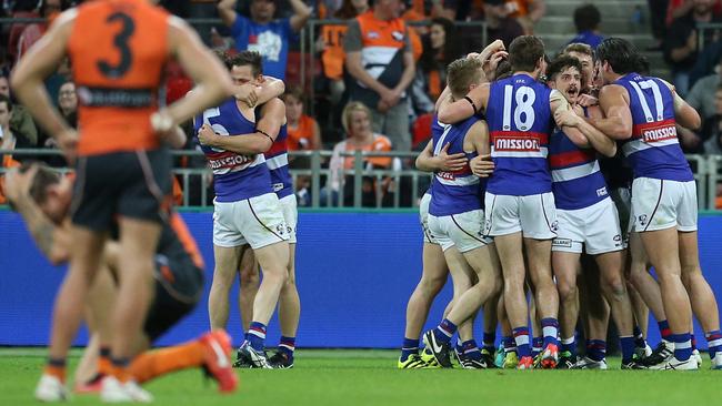 Bulldogs celebrate after beating the Giants on Saturday night.