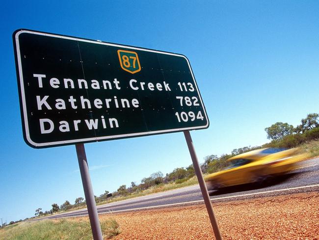 PIRATE: Undated : 2001 Porsche 911 turbo. road sign showing distance to Tennant Creek 113, Katherine 782, Darwin 1094 - roads outback NT