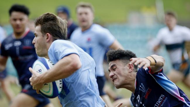 Waratahs' Liam Grover chased by Melbourne Rebels' Journey Ioane.