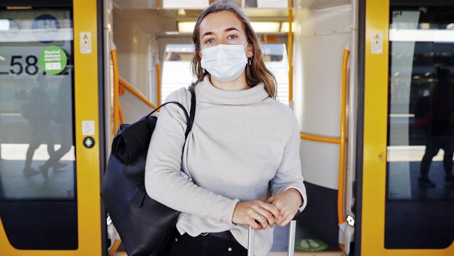 Lily Leighton wears her mask while catching a train. Picture: Sam Ruttyn