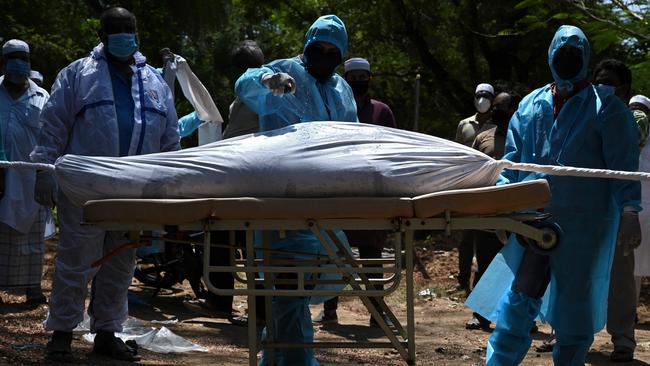 Volunteers prepare to bury a body of a Covid-19 coronavirus victim in Chennai, India. The Delta variant emerged in India around October last year and has now spread to 100 countries. Picture: AFP