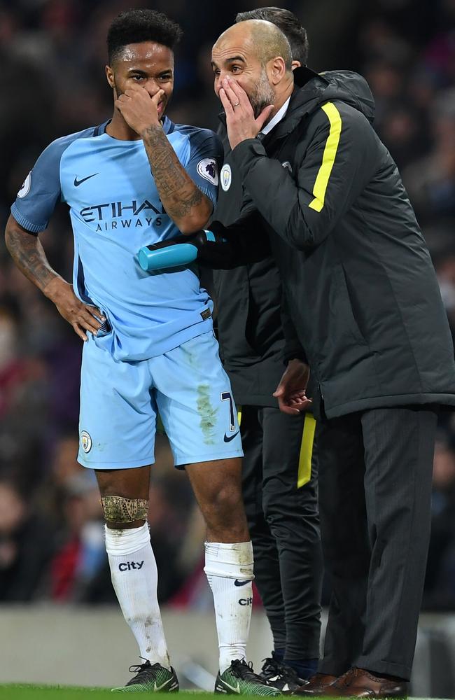 Pep Guardiola (R) talks to Manchester City's English midfielder Raheem Sterling (L)