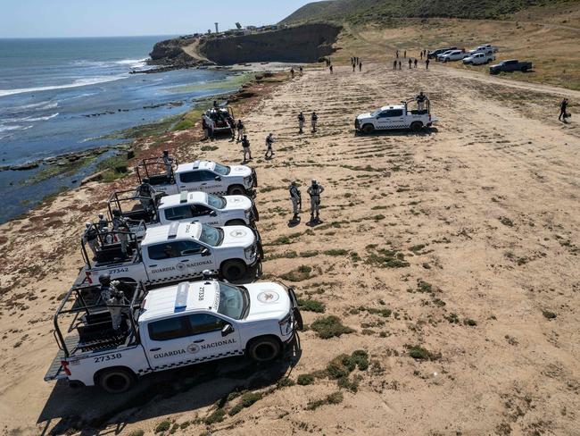 National Guard vehicles at the site where the Australian brothers and their friend were camping before disappearing. Picture: AFP