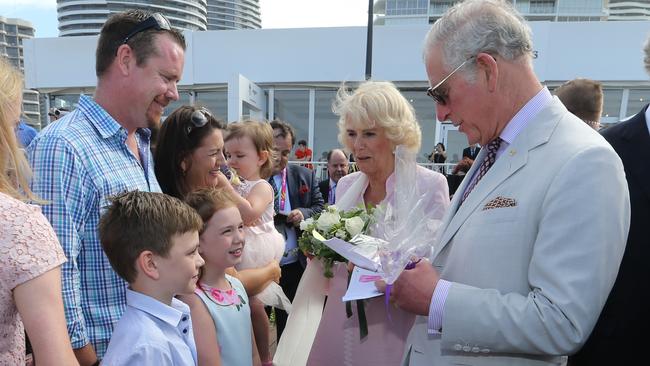 King Charles III &amp; new Queen Consort Camilla at Kurrawa Surf Club with locals Patrick Riley, 8, and Annie Riley, 10 who presented them with Anzac Biscuits and flowers. Picture Glenn Hampson