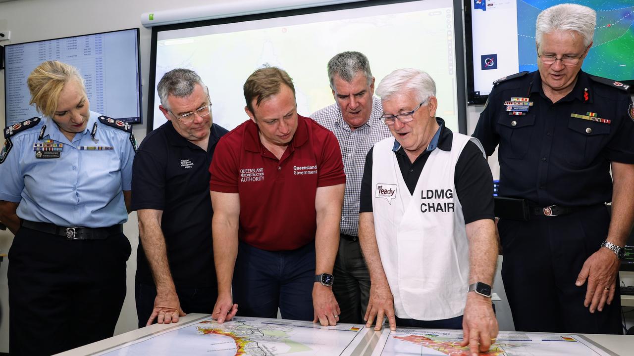 Queensland Police Commissioner Katarina Carroll, Senator Murray Watt, Deputy Premier Steven Miles, Queensland Local Government Minister Mark Furner, Cairns Mayor Terry James and Queensland Fire and Emergency Services Assistant Commissioner Brad Commens look over flood zone maps for the Cairns region at the Cairns Local Disaster Coordination Centre. Picture: Brendan Radke