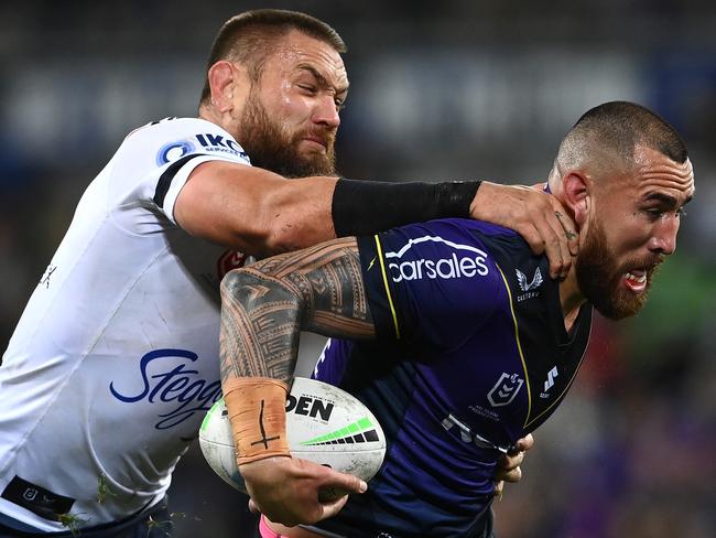 MELBOURNE, AUSTRALIA - AUGUST 26:  Nelson Asofa-Solomona of the Storm is tackled by Jared Waerea-Hargreaves of the Roosters  during the round 24 NRL match between the Melbourne Storm and the Sydney Roosters at AAMI Park on August 26, 2022, in Melbourne, Australia. (Photo by Quinn Rooney/Getty Images)