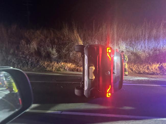 Man aged in his 60s taken to hospital after car flips on Bruce Highway