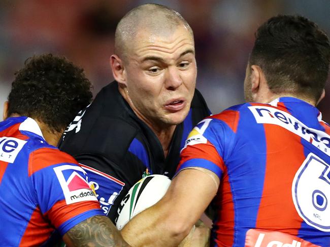 Bulldog David Klemmer tackled by the Dane Gagai and Brock Lamb  during the NRL game between the Newcastle Knights and the Canterbury Bulldogs at McDonald Jones Stadium , Newcastle . Picture : Gregg Porteous