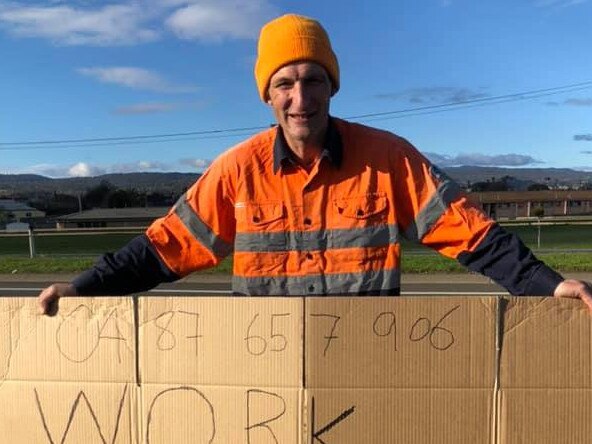 Michael Cann with sign  in Launceston looking for work. Picture: Supplied